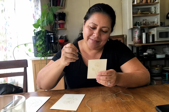 Theresa D. stitching her paper-embroidery card